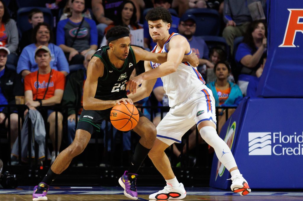 Dec 29, 2024; Gainesville, Florida, USA; Stetson Hatters guard Abramo Canka (22) posts up against Florida Gators guard Walter Clayton Jr. (1) during the second half at Exactech Arena at the Stephen C. O'Connell Center. Mandatory Credit: Matt Pendleton-Imagn Images