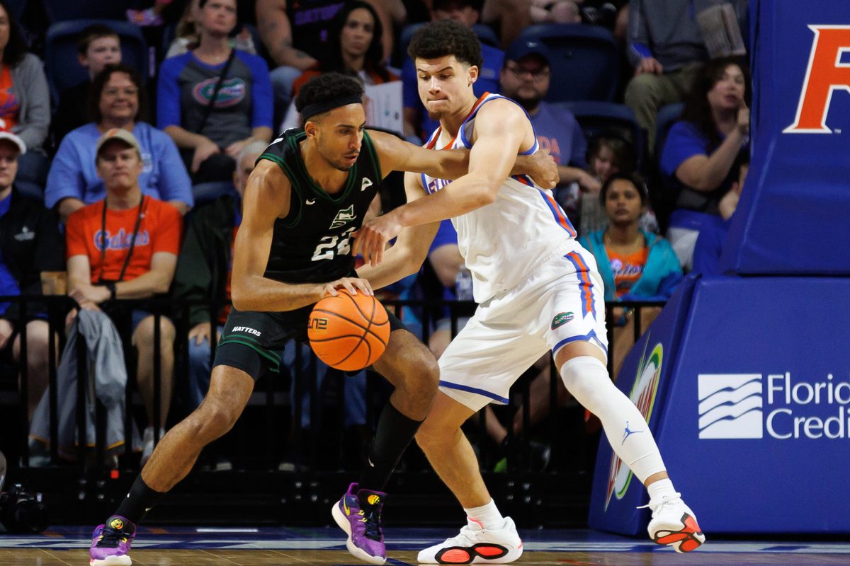 Dec 29, 2024; Gainesville, Florida, USA; Stetson Hatters guard Abramo Canka (22) posts up against Florida Gators guard Walter Clayton Jr. (1) during the second half at Exactech Arena at the Stephen C. O'Connell Center. Mandatory Credit: Matt Pendleton-Imagn Images