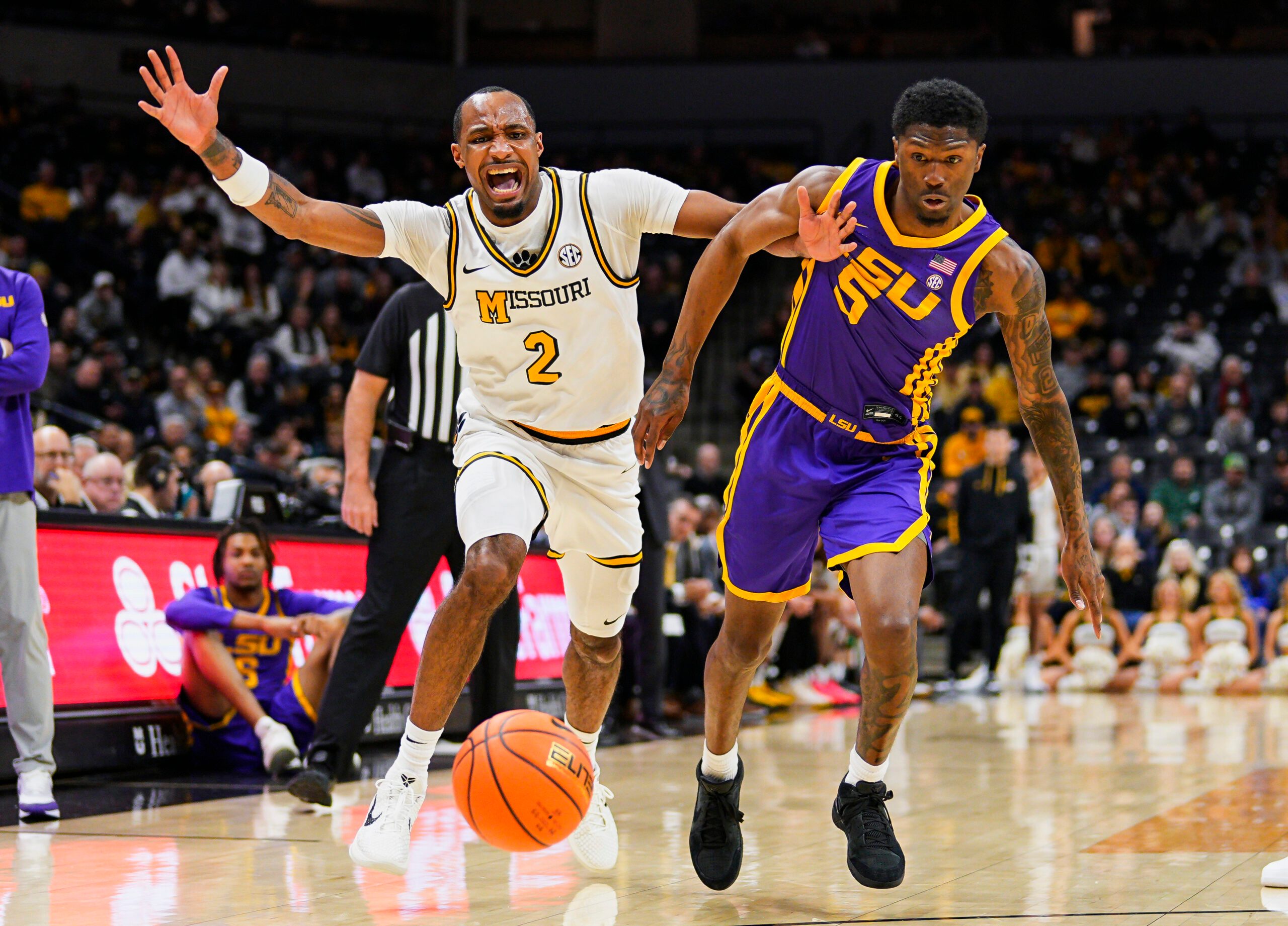 Jan 7, 2025; Columbia, Missouri, USA; Missouri Tigers guard Tamar Bates (2) and LSU Tigers guard Cam Carter (5) fight for a loose ball during the first half at Mizzou Arena. Mandatory Credit: Jay Biggerstaff-Imagn Images