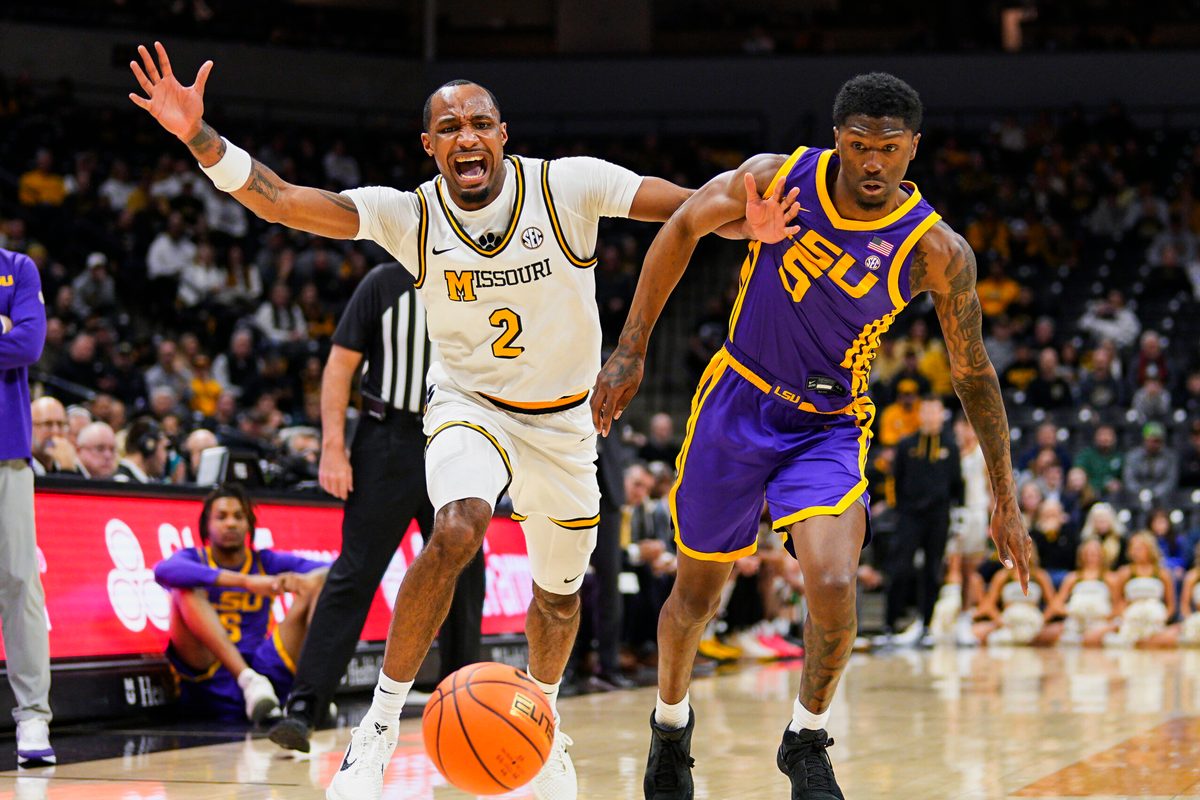 Jan 7, 2025; Columbia, Missouri, USA; Missouri Tigers guard Tamar Bates (2) and LSU Tigers guard Cam Carter (5) fight for a loose ball during the first half at Mizzou Arena. Mandatory Credit: Jay Biggerstaff-Imagn Images