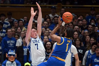 Jan 7, 2025; Durham, North Carolina, USA; Pitt Panthers guard Damian Dunn (1) shoots over Duke Blue Devils forward Kon Knueppel (7) during the second half at Cameron Indoor Stadium. Mandatory Credit: Rob Kinnan-Imagn Images