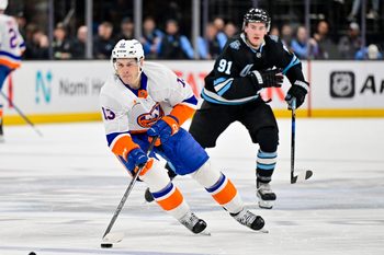 Jan 11, 2025; Salt Lake City, Utah, USA; New York Islanders center Mathew Barzal (13) makes a fast break against Utah Hockey Club right wing Josh Doan (91) during third period at the Delta Center. Mandatory Credit: Christopher Creveling-Imagn Images