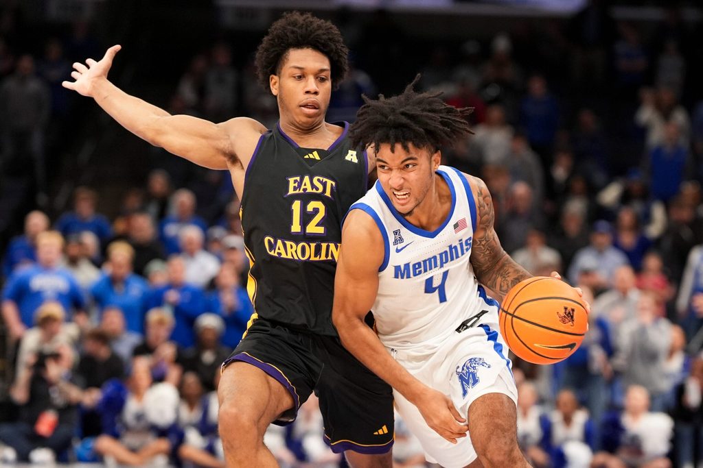 Memphis' PJ Haggerty (4) drives to the basket as East Carolina's Jordan Riley (12) guards him during the game between East Carolina University and University of Memphis at FedExForum in Memphis, Tenn., on Saturday, January 11, 2025.