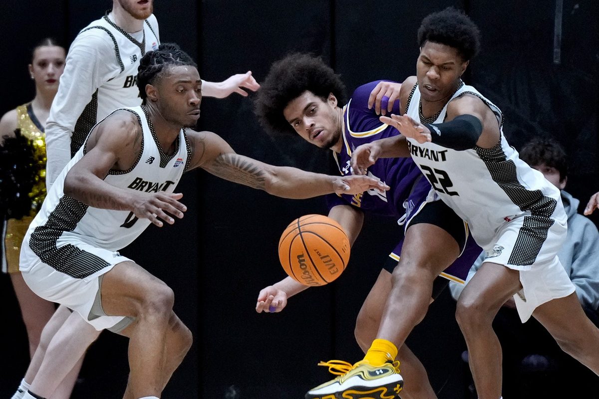 L to ri Bryant Bulldogs Connor Withers, Earl Timberlake and Keyshawn Mitchell try to beat Great Dane Justin Neely to a runaway rebound in the first half.