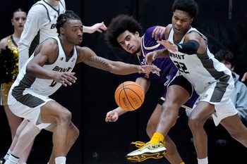 L to ri Bryant Bulldogs Connor Withers, Earl Timberlake and Keyshawn Mitchell try to beat Great Dane Justin Neely to a runaway rebound in the first half.
