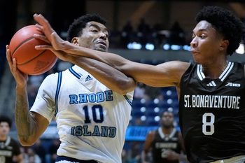 URI Rams guard Jamarques Lawrence fiends off the reaching arm of St. Bonaventure's Jonah Hinton during first half action.
