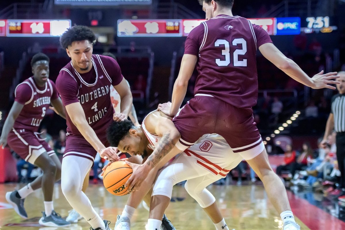 Southern Illinois’ Davion Sykes (4) and Jarrett Hensley (32) pressure Bradley’s Zek Montgomery in the first half of their MVC basketball game Wednesday, Feb. 12, 2025 at Carver Arena in Peoria. The Braves defeated the Salukis 78-64.