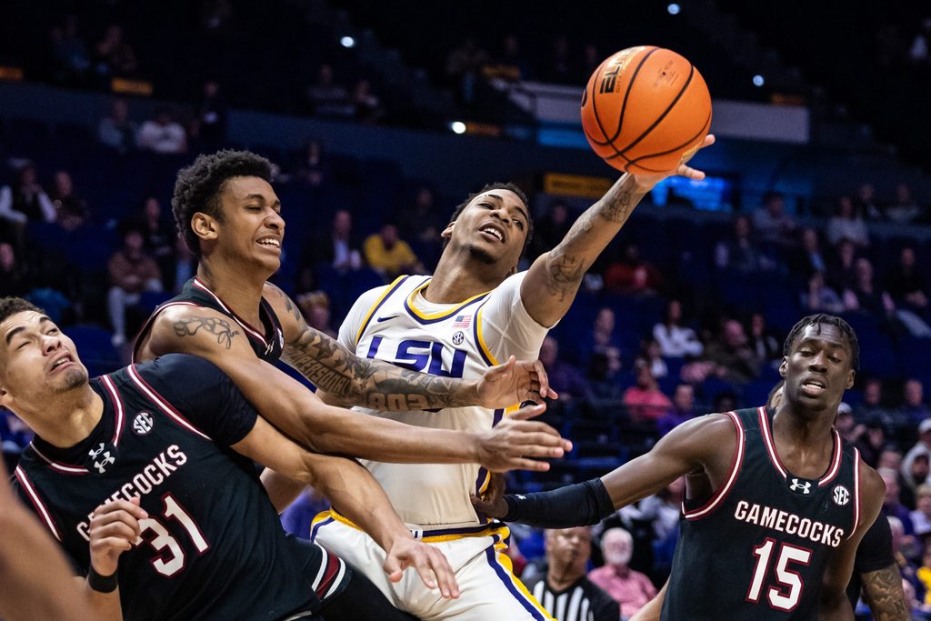 Feb 18, 2025; Baton Rouge, Louisiana, USA; South Carolina Gamecocks guard Arden Conyers (21) and LSU Tigers forward Robert Miller III (6) fight for a rebound during the first half at Pete Maravich Assembly Center. Mandatory Credit: Stephen Lew-Imagn Images
