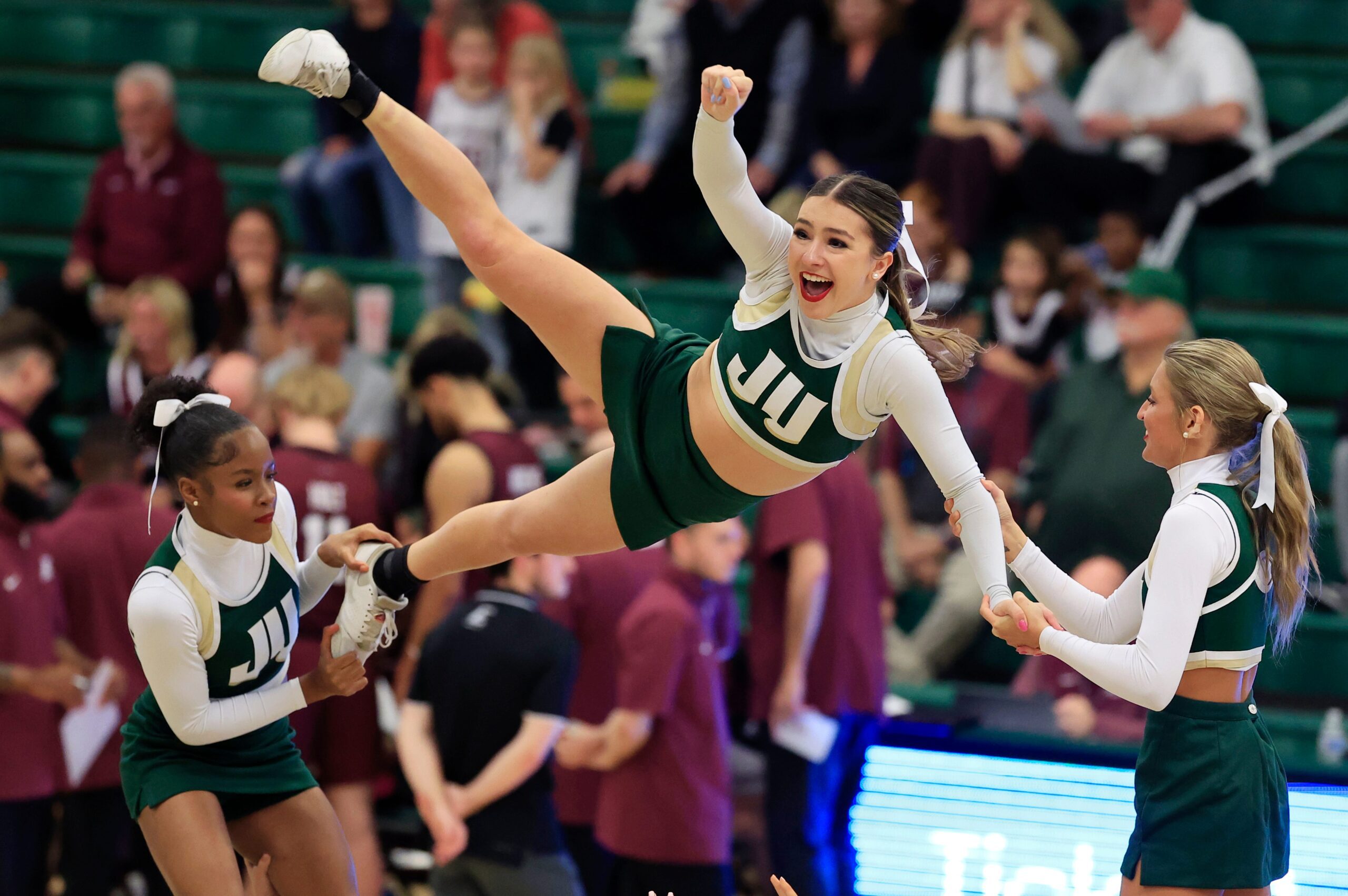 Jacksonville Dolphins cheerleaders perform a stunt during a time out during the second half of the quarterfinal round of the ASUN men’s basketball tournament at Swisher Gymnasium Monday, March 2, 2025 in Jacksonville, Fla. JU rallied to defeat EKU 78-67. [Corey Perrine/Florida Times-Union]