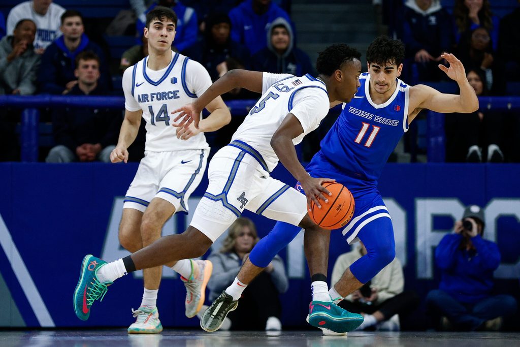 Mar 4, 2025; Colorado Springs, Colorado, USA; Air Force Falcons guard Ethan Taylor (5) controls the ball under pressure from Boise State Broncos guard Alvaro Cardenas (11) as forward Beau Becker (14) defends in the first half at Clune Arena. Mandatory Credit: Isaiah J. Downing-Imagn Images