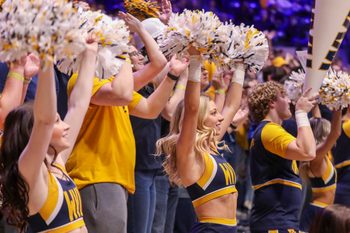 Mar 8, 2025; Morgantown, West Virginia, USA; West Virginia Mountaineers cheerleaders perform during the second half against the UCF Knights at WVU Coliseum. Mandatory Credit: Ben Queen-Imagn Images