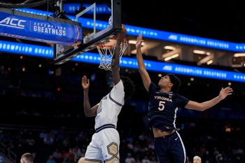 Mar 12, 2025; Charlotte, NC, USA; Georgia Tech Yellow Jackets forward Baye Ndongo (11) goes to the basket defended by Virginia Cavaliers forward Jacob Cofie (5) during the second half at Spectrum Center. Mandatory Credit: Jim Dedmon-Imagn Images