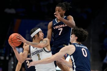 Mar 12, 2025; Charlotte, NC, USA; Georgia Tech Yellow Jackets guard Naithan George (1) with the ball as Virginia Cavaliers guard Dai Dai Ames (7) and forward Blake Buchanan (0) defend in the second half at Spectrum Center. Mandatory Credit: Bob Donnan-Imagn Images
