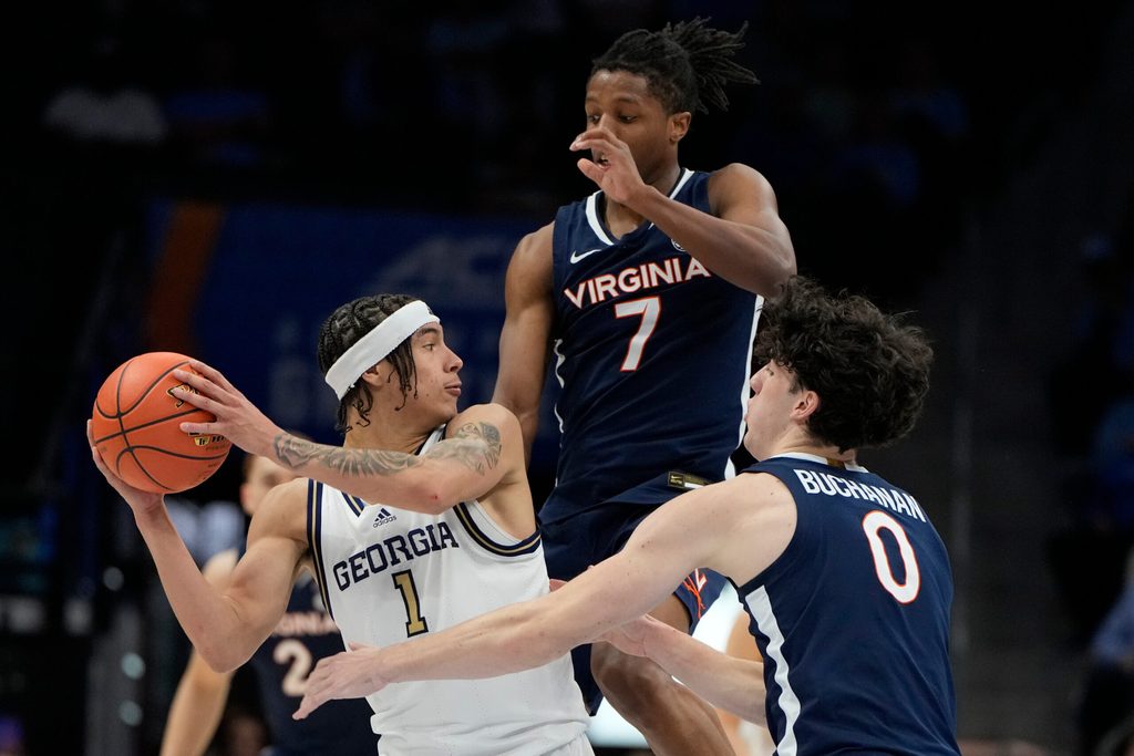 Mar 12, 2025; Charlotte, NC, USA; Georgia Tech Yellow Jackets guard Naithan George (1) with the ball as Virginia Cavaliers guard Dai Dai Ames (7) and forward Blake Buchanan (0) defend in the second half at Spectrum Center. Mandatory Credit: Bob Donnan-Imagn Images