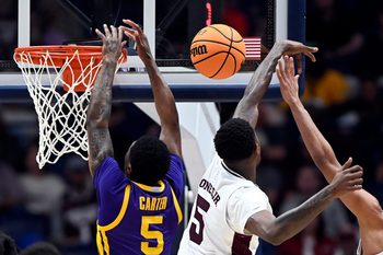 Mississippi State guard Shawn Jones Jr. (5) swats a shot by LSU guard Cam Carter (5) during a NCAA college basketball first round game at the men’s Southeastern Conference Tournament Wednesday, March 12, 2025, in Nashville, Tenn.