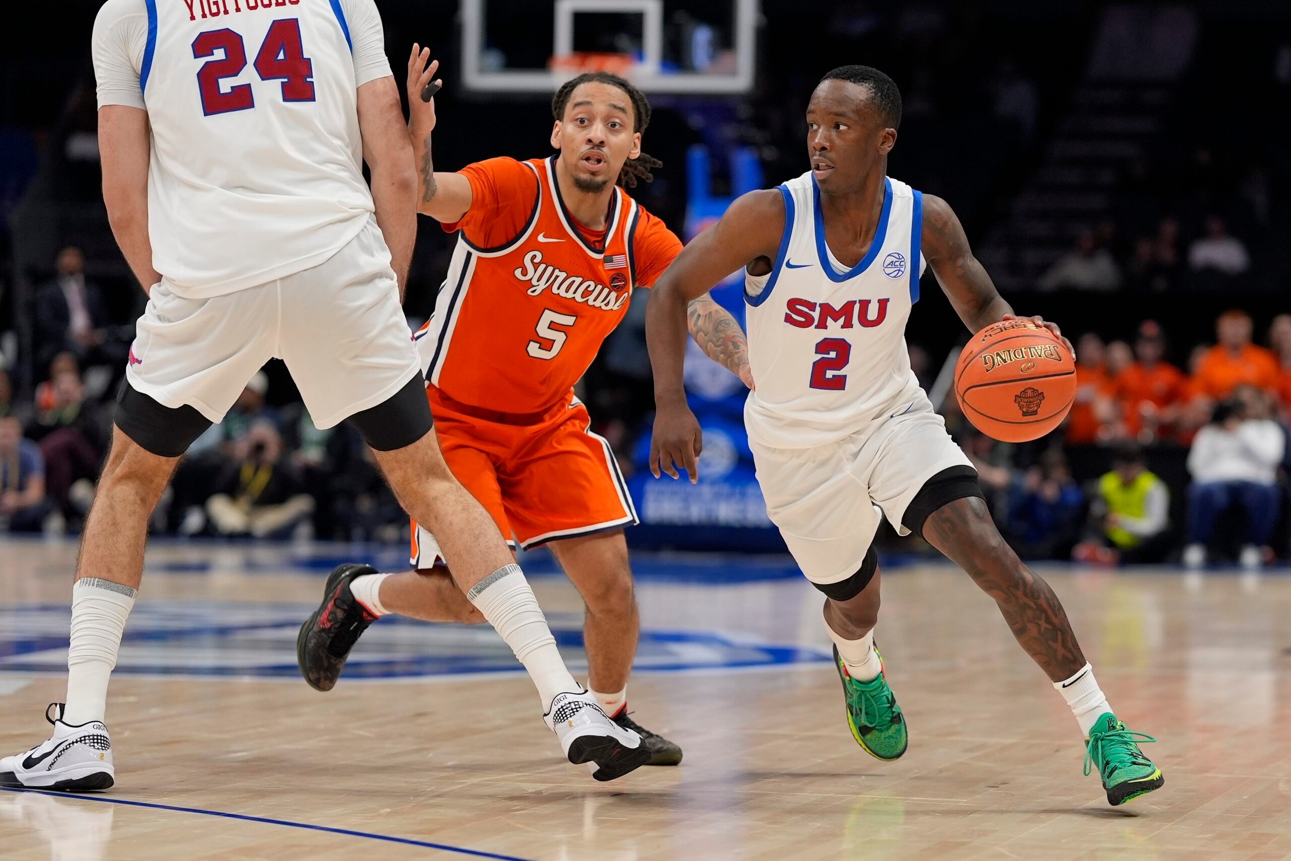 Mar 12, 2025; Charlotte, NC, USA;Southern Methodist Mustangs guard Boopie Miller (2) goes to the basket against Syracuse Orange guard Jaquan Carlos (5) during the second half at Spectrum Center. Mandatory Credit: Jim Dedmon-Imagn Images