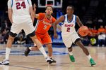 Mar 12, 2025; Charlotte, NC, USA;Southern Methodist Mustangs guard Boopie Miller (2) goes to the basket against Syracuse Orange guard Jaquan Carlos (5) during the second half at Spectrum Center. Mandatory Credit: Jim Dedmon-Imagn Images