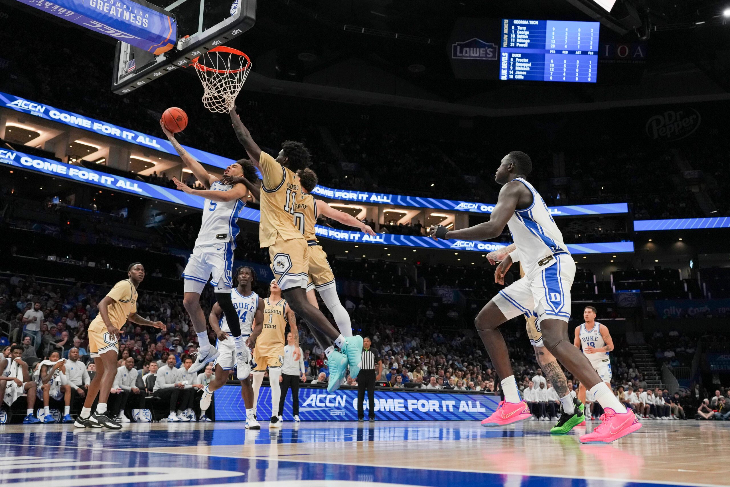 Mar 13, 2025; Charlotte, NC, USA; Duke Blue Devils guard Tyrese Proctor (5) at the basket against Georgia Tech Yellow Jackets forward Baye Ndongo (11) during the second half at Spectrum Center. Mandatory Credit: Jim Dedmon-Imagn Images