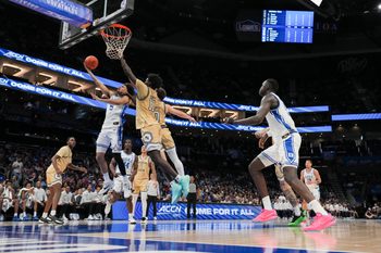 Mar 13, 2025; Charlotte, NC, USA; Duke Blue Devils guard Tyrese Proctor (5) at the basket against Georgia Tech Yellow Jackets forward Baye Ndongo (11) during the second half at Spectrum Center. Mandatory Credit: Jim Dedmon-Imagn Images