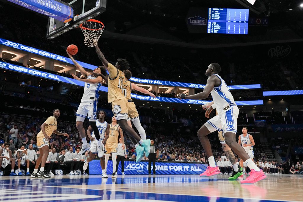 Mar 13, 2025; Charlotte, NC, USA; Duke Blue Devils guard Tyrese Proctor (5) at the basket against Georgia Tech Yellow Jackets forward Baye Ndongo (11) during the second half at Spectrum Center. Mandatory Credit: Jim Dedmon-Imagn Images