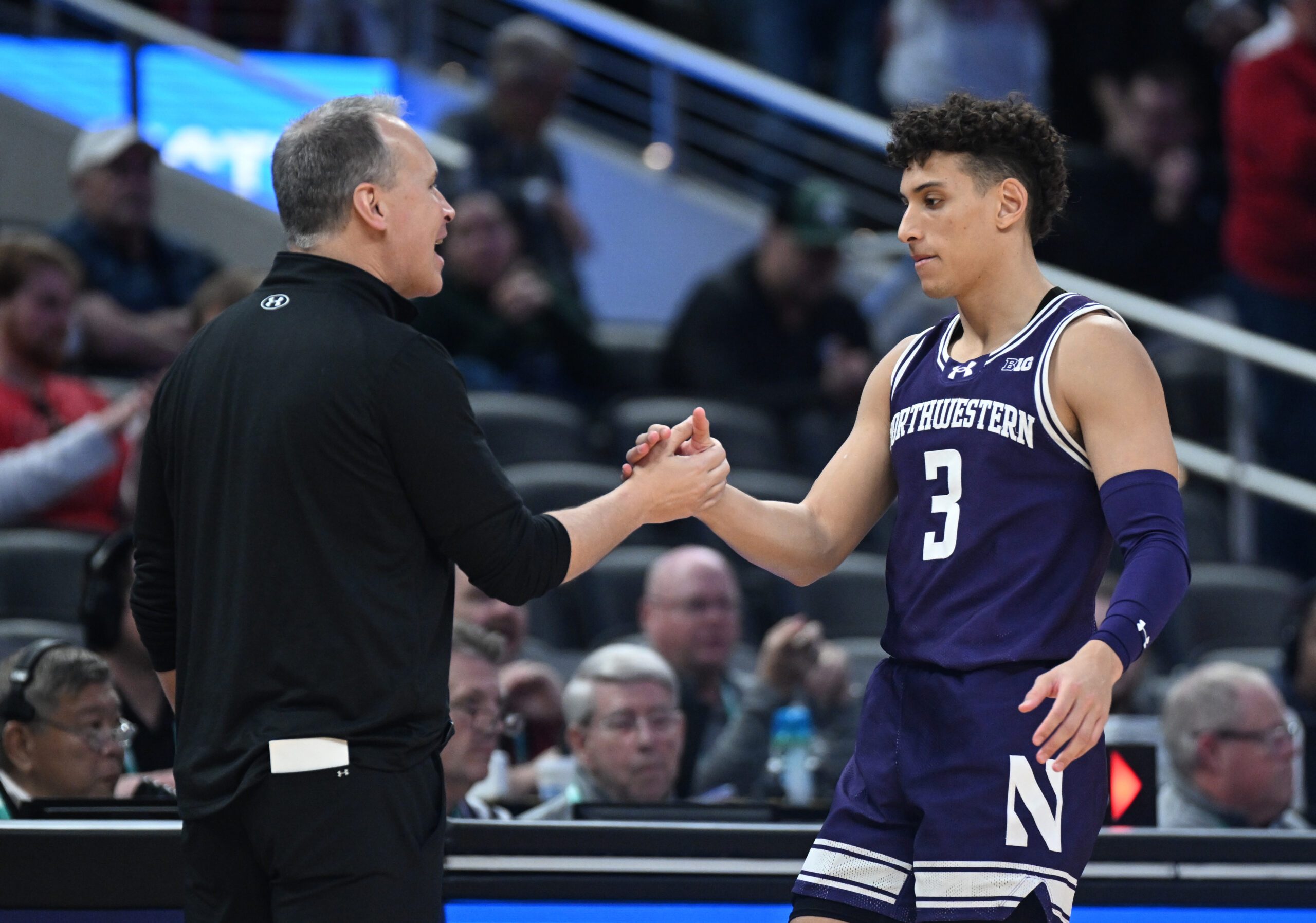 Mar 13, 2025; Indianapolis, IN, USA; Northwestern Wildcats head coach Chris Collins greets Northwestern Wildcats guard Ty Berry (3) as he checks out of the game during the second half against the Wisconsin Badgers at Gainbridge Fieldhouse. Mandatory Credit: Robert Goddin-Imagn Images