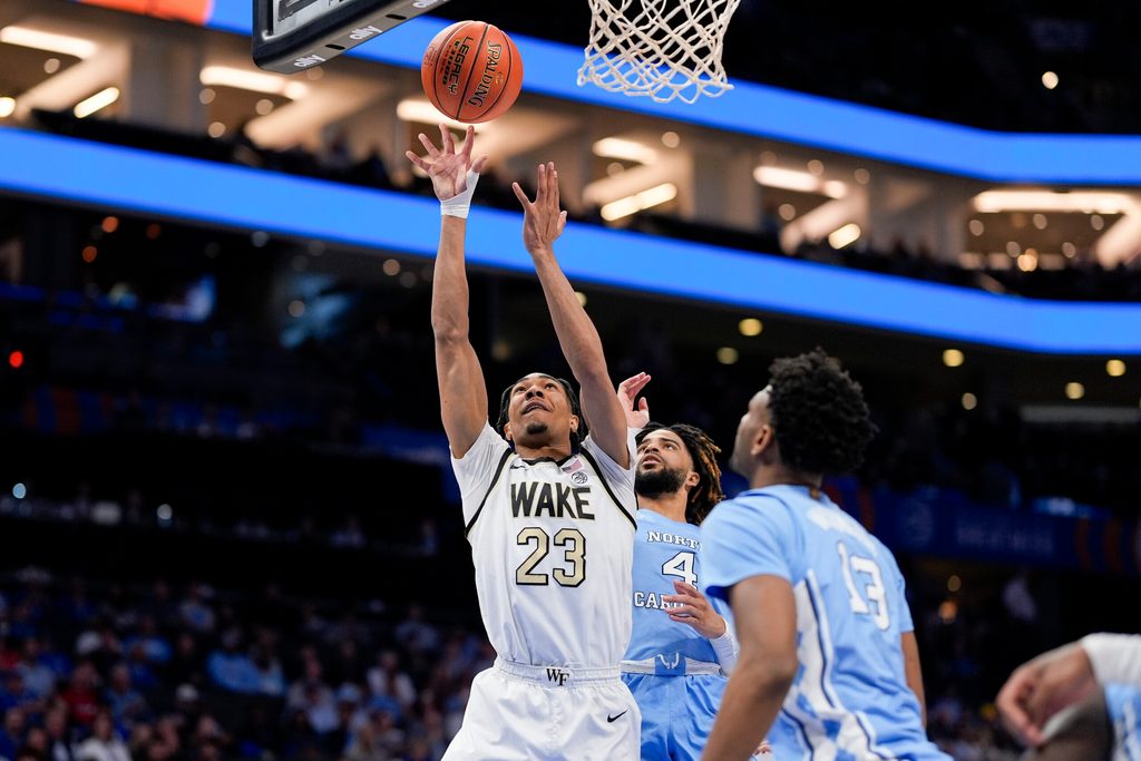 Mar 13, 2025; Charlotte, NC, USA; Wake Forest Demon Deacons guard Hunter Sallis (23) goes to the basket chased by North Carolina Tar Heels guard RJ Davis (4) during the second half at Spectrum Center. Mandatory Credit: Jim Dedmon-Imagn Images