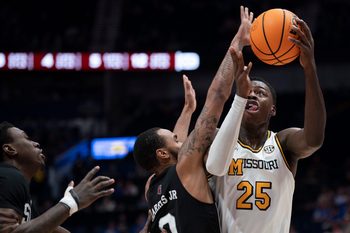 Missouri Tigers guard Mark Mitchell (25) shoots over Mississippi State Bulldogs guard Claudell Harris Jr. (0) during their second round game of the SEC Men's Basketball Tournament at Bridgestone Arena in Nashville, Tenn., Thursday, March 13, 2025.