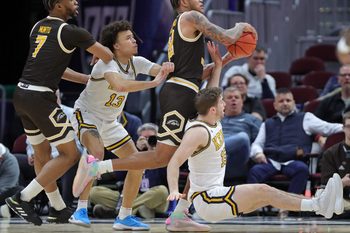 Western Michigan Broncos guard Markhi Strickland (22) controls the ball between Kent State Golden Flashes guard Jalen Sullinger (13) and guard Mike Bekelja (15) during the first half of an NCAA college basketball game in the quarterfinals of the Mid-American Conference Tournament at Rocket Arena on Thursday, March 13, 2025, in Cleveland, Ohio.