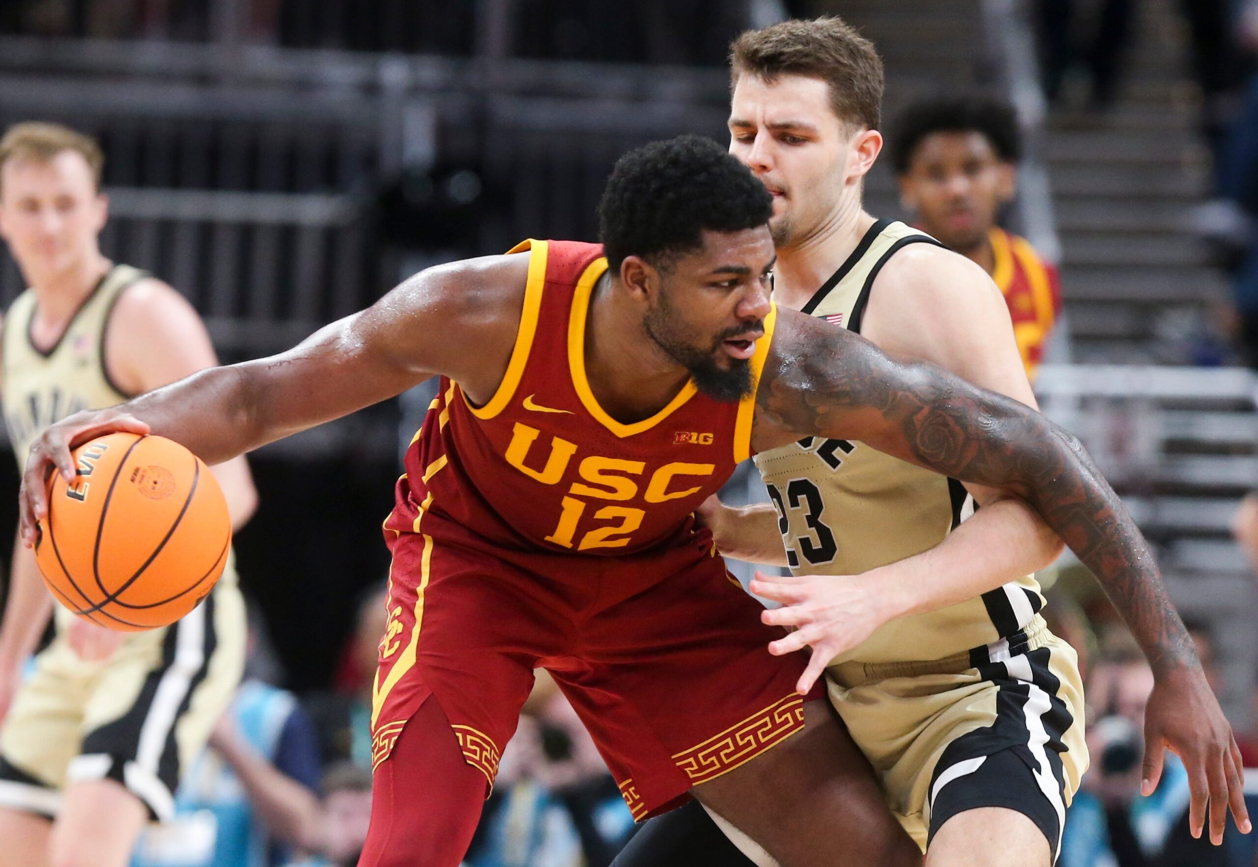 USC Trojans forward Rashaun Agee (12) is defended by Purdue Boilermakers forward Camden Heide (23) Thursday, March 13, 2025, during the Big Ten Men’s Basketball Tournament game at Gainbridge Fieldhouse in Indianapolis. Purdue Boilermakers won 76-71.