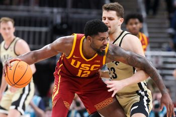 USC Trojans forward Rashaun Agee (12) is defended by Purdue Boilermakers forward Camden Heide (23) Thursday, March 13, 2025, during the Big Ten Men’s Basketball Tournament game at Gainbridge Fieldhouse in Indianapolis. Purdue Boilermakers won 76-71.