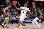 Akron Zips guard Tavari Johnson (5) looks to the basket ahead of Toledo Rockets guard Sonny Wilson (3) during the first half of an NCAA college basketball game in the semifinals of the Mid-American Conference Tournament at Rocket Arena on Friday, March 14, 2025, in Cleveland, Ohio.