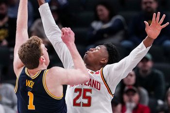Maryland Terrapins center Derik Queen (25) attempts to stop Michigan Wolverines center Danny Wolf (1) on Saturday, March 15, 2025, in a semifinals game at the 2025 TIAA Big Ten Men’s Basketball Tournament between the Michigan Wolverines and the Maryland Terrapins at Gainbridge Fieldhouse in Indianapolis.