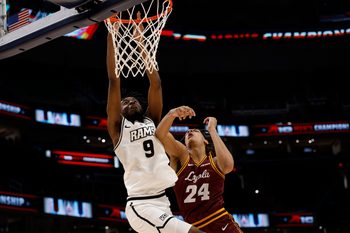 Mar 15, 2025; Washington, D.C., USA; VCU Rams forward Luke Bamgboye (9) is fouled while attempting to dunk the ball by Loyola Chicago Ramblers center Miles Rubin (24) in the second half at Capital One Arena. Mandatory Credit: Geoff Burke-Imagn Images