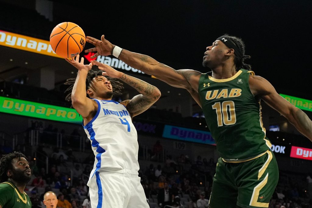 Mar 16, 2025; Fort Worth, TX, USA; Memphis Tigers guard PJ Haggerty (4) has his shot bloked by UAB Blazers guard Alejandro Vasquez (10) during the second half at Dickies Arena. Mandatory Credit: Chris Jones-Imagn Images