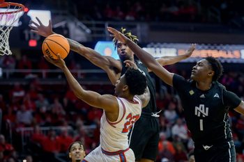 Bradley’s Jaquan Johnson (22) goes to the basket against North Alabama’s Donte Bacchus (1) and Corneilous Williams in the first half of their first-round NIT basketball game Wednesday, March 19, 2025. The Braves advanced with a 71-62 victory.