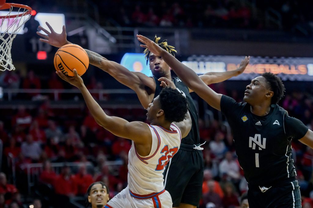 Bradley’s Jaquan Johnson (22) goes to the basket against North Alabama’s Donte Bacchus (1) and Corneilous Williams in the first half of their first-round NIT basketball game Wednesday, March 19, 2025. The Braves advanced with a 71-62 victory.