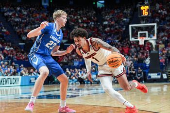Louisville Cardinals guard J'Vonne Hadley (1) tries to drive around Creighton Bluejays forward Jackson McAndrew (23) during the second half in the first round game of the 2025 NCAA men's basketball tournament at Rupp Arena in Lexington, Kentucky Thursday March 20, 2025.