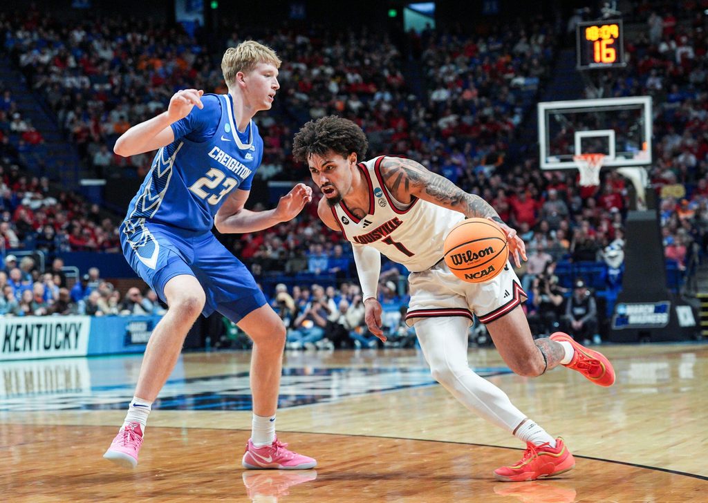 Louisville Cardinals guard J'Vonne Hadley (1) tries to drive around Creighton Bluejays forward Jackson McAndrew (23) during the second half in the first round game of the 2025 NCAA men's basketball tournament at Rupp Arena in Lexington, Kentucky Thursday March 20, 2025.
