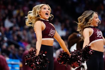 Mar 20, 2025; Denver, CO, USA; A cheerleader for the Montana Grizzlies performs during the second half against the Wisconsin Badgers in the first round of the NCAA Tournament at Ball Arena. Mandatory Credit: Ron Chenoy-Imagn Images
