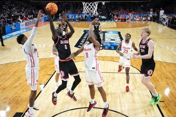 Mar 20, 2025; Wichita, KS, USA; SIU Edwardsville Cougars forward Ring Malith (0) shoots against Houston Cougars guard Mylik Wilson (8) and forward Joseph Tugler (11) in the second half of a first round men’s NCAA Tournament game at Intrust Bank Arena. Mandatory Credit: Kirby Lee-Imagn Images