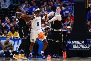 Mar 20, 2025; Denver, CO, USA; Brigham Young Cougars forward Mawot Mag (0) battles for the ball with VCU Rams guard Joe Bamisile (22) and guard Max Shulga (11) during the second half in the first round of the NCAA Tournament at Ball Arena. Mandatory Credit: Isaiah J. Downing-Imagn Images