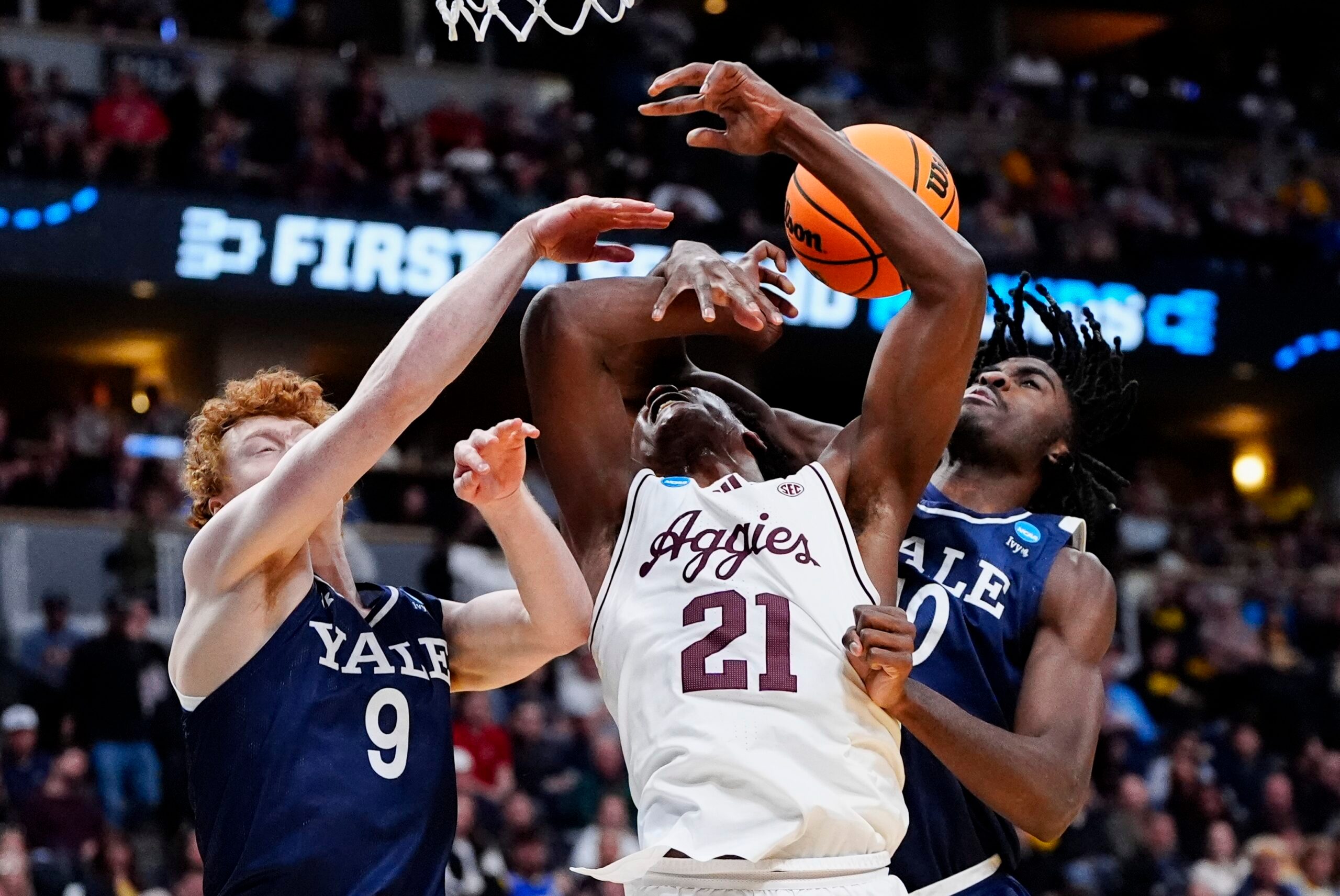 March 20, 2025; Denver, CO, USA; Texas A&M Aggies forward Pharrel Payne (21) is fouled by Yale Bulldogs center Samson Aletan (10) as forward Riley Fox (9) defends during the second half at Ball Arena. Mandatory Credit: Ron Chenoy-Imagn Images