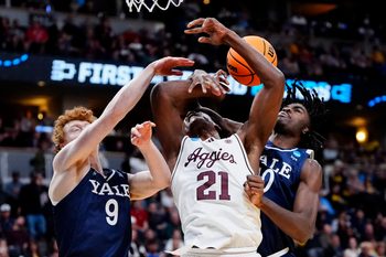 March 20, 2025; Denver, CO, USA; Texas A&M Aggies forward Pharrel Payne (21) is fouled by Yale Bulldogs center Samson Aletan (10) as forward Riley Fox (9) defends during the second half at Ball Arena. Mandatory Credit: Ron Chenoy-Imagn Images