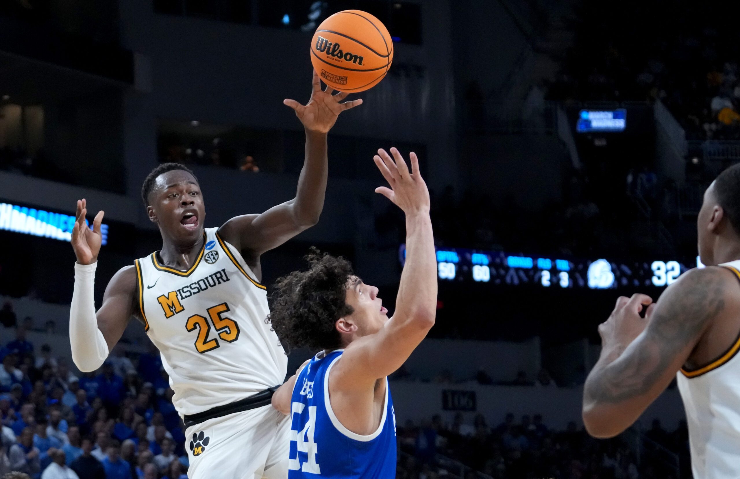 Mar 20, 2025; Wichita, KS, USA; Missouri Tigers guard Mark Mitchell (25) passes against Drake Bulldogs forward Daniel Abreu (54) in the first half of a first round men’s NCAA Tournament game at Intrust Bank Arena. Mandatory Credit: Kirby Lee-Imagn Images