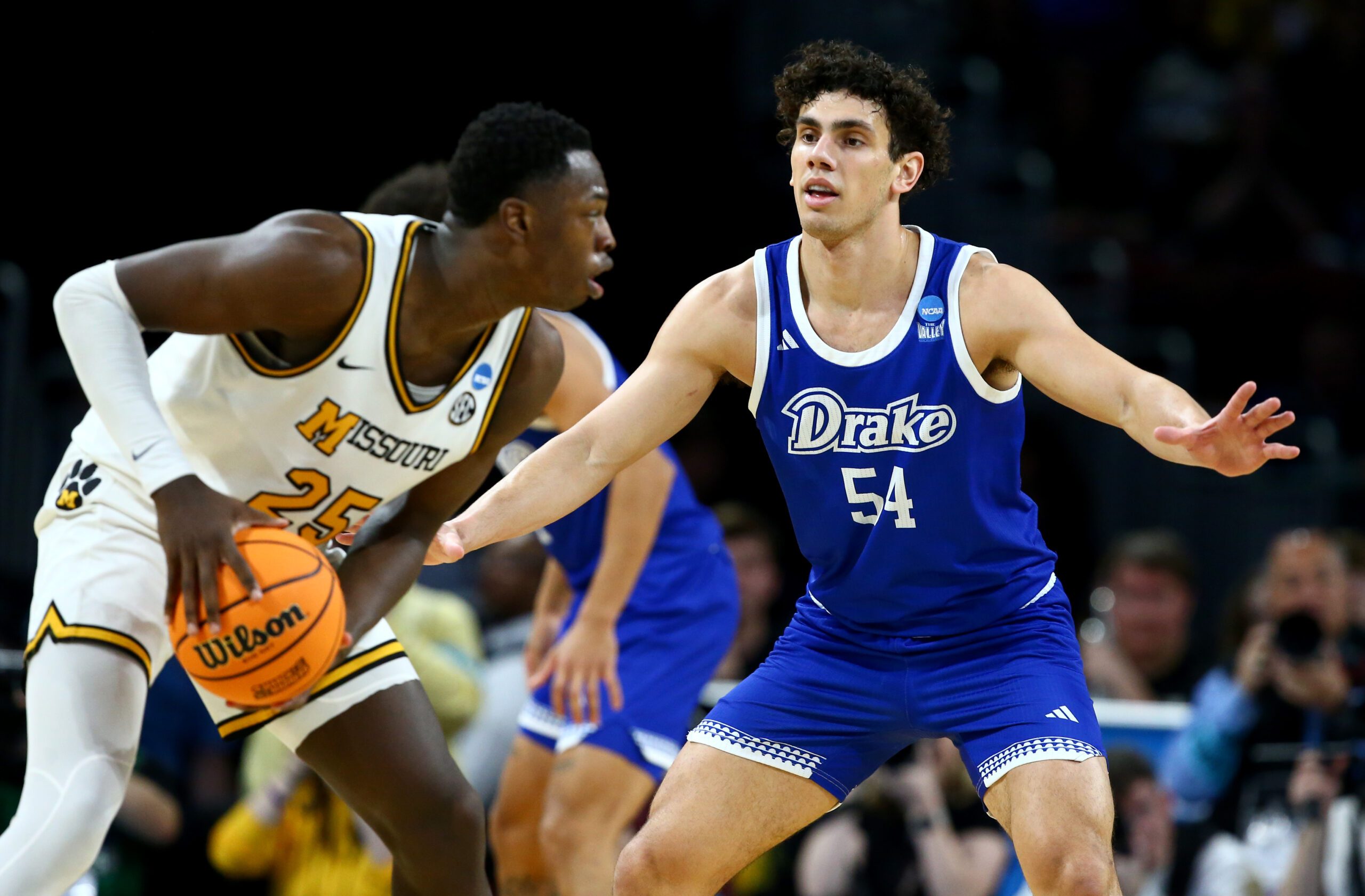 Mar 20, 2025; Wichita, KS, USA; Drake Bulldogs forward Daniel Abreu (54) defends Missouri Tigers guard Mark Mitchell (25) in the second half of a first round men’s NCAA Tournament game at Intrust Bank Arena. Mandatory Credit: Nick Tre. Smith-Imagn Images