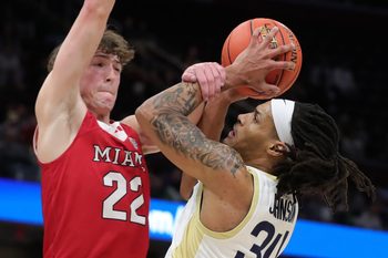 Akron Zips guard Nate Johnson (34) is fouled by Miami RedHawks forward Brant Byers (22) during the Mid-American Conference Tournament championship game March 15, 2025, in Cleveland, Ohio.