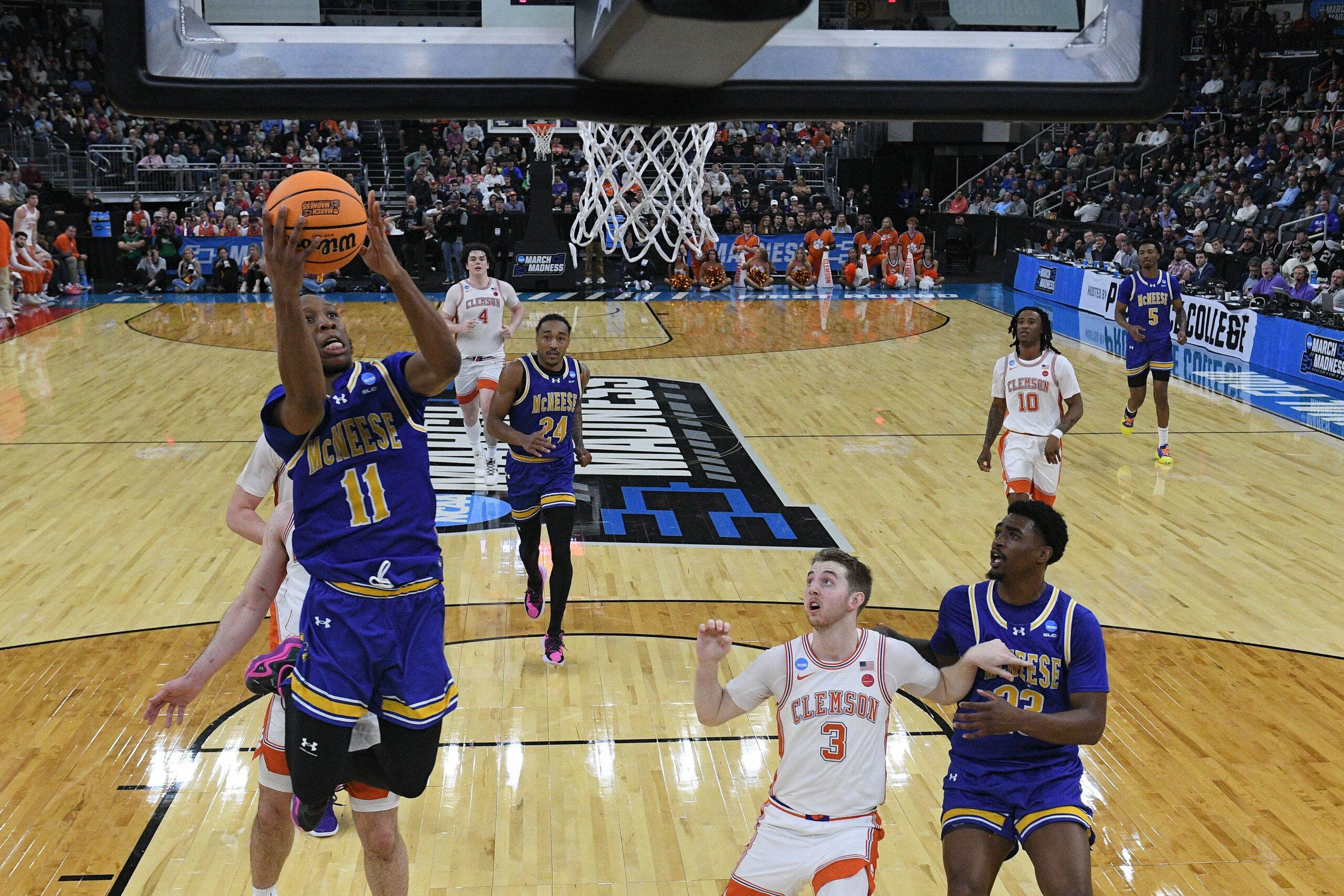 Mar 20, 2025; Providence, RI, USA; McNeese State Cowboys guard Quadir Copeland (11) shoots the ball over Clemson Tigers guard Jake Heidbreder (3) during the second half at Amica Mutual Pavilion. Mandatory Credit: Eric Canha-Imagn Images