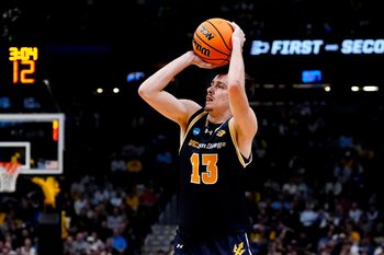 March 20, 2025; Denver, CO, USA; UC San Diego Tritons guard Tyler McGhie (13) shoots a three point basket during the second half against the Michigan Wolverines at Ball Arena. Mandatory Credit: Ron Chenoy-Imagn Images