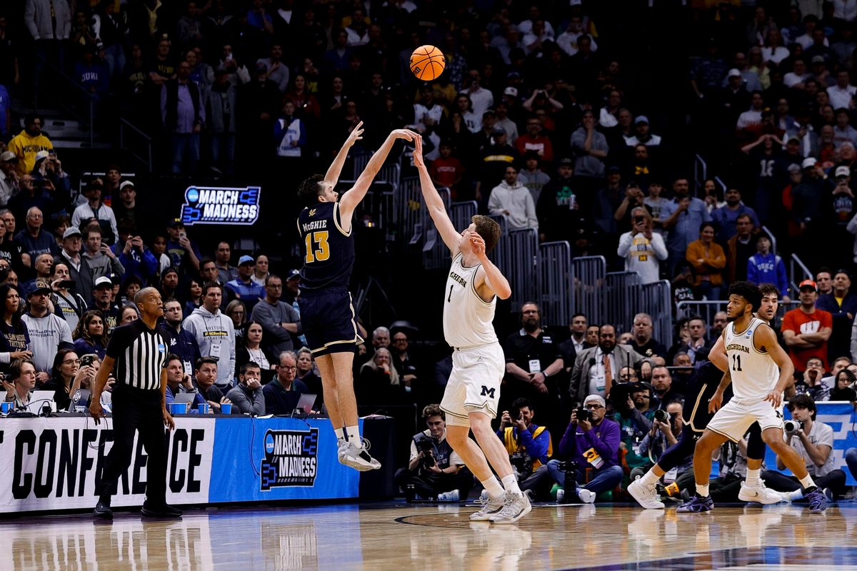March 20, 2025; Denver, CO, USA; UC San Diego Tritons guard Tyler McGhie (13) shoots over Michigan Wolverines center Danny Wolf (1) during the second half at Ball Arena. Mandatory Credit: Isaiah J. Downing-Imagn Images
