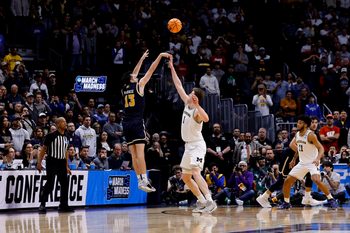March 20, 2025; Denver, CO, USA; UC San Diego Tritons guard Tyler McGhie (13) shoots over Michigan Wolverines center Danny Wolf (1) during the second half at Ball Arena. Mandatory Credit: Isaiah J. Downing-Imagn Images